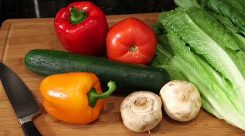 Overhead pan across vegetables on cutting board Stock Footage 61401211