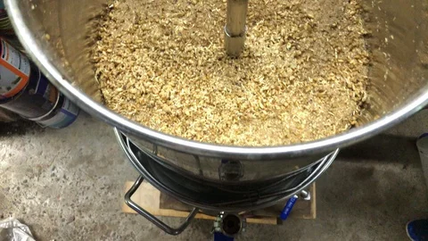 Overhead panning of grain in home brew kettle Stock Footage 127828811