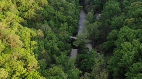Overhead parallax looking down at a bridge over a forest river Stock Footage 111345217