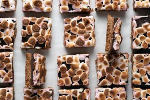 Overhead pattern of many toasted s'mores bars on white background Stock Photos