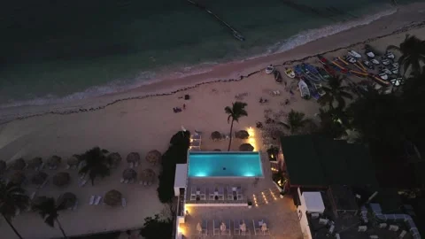 Overhead perspective of beachfront building featuring pool during twilight Stock Footage 272612049