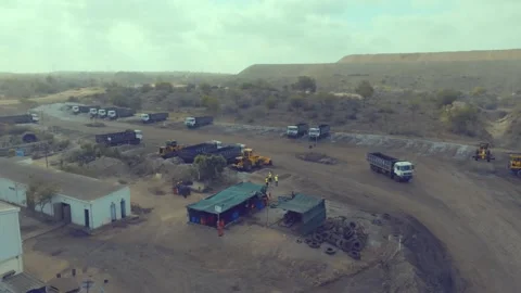 Overhead perspective of busy heavy equipment and dump trucks operating in the Stock Footage 337907800