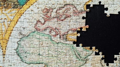 Overhead perspective completed puzzle showing world map. Vintage style jigsaw Stock Footage 332310237