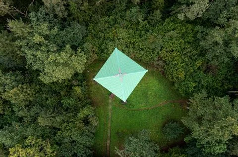 Overhead perspective of a observation tower cabin nestled in lush woodland .. Stock Photos
