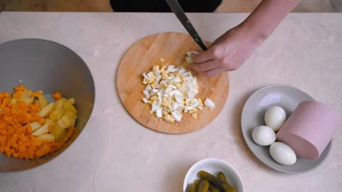 Overhead perspective revealing process of assembling colorful vegetable salad Stock Footage 330024297