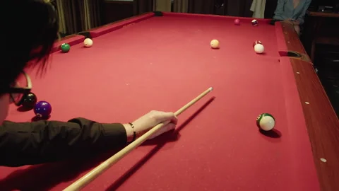 Overhead perspective showing player practicing aiming skills on red pool table Video stock 329193001