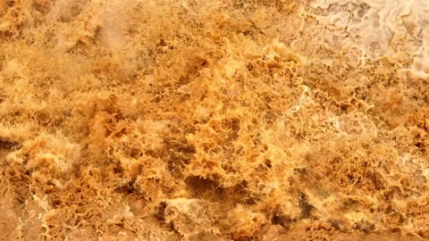 Overhead perspective shows floodwaters surging forcefully over rocks. Video stock 310708498