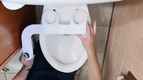Overhead of Plumber Assembling Sanitary hygiene Bidet Sprayer Household Toilet Stock Footage 133940075