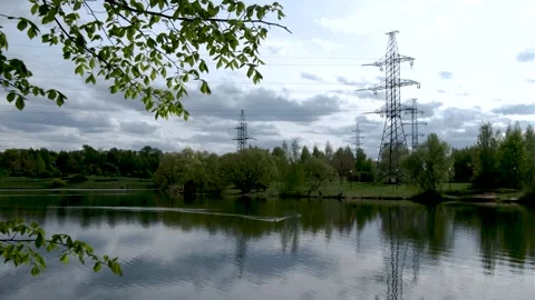 Overhead power line support (transmission line support) in the park among trees 库存影片 240433985