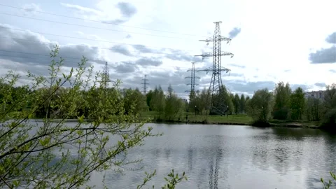 Overhead power line support (transmission line support) in the park among trees 库存影片 240435202