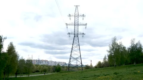 Overhead power line support (transmission line support) in the park among trees 库存影片 240435844