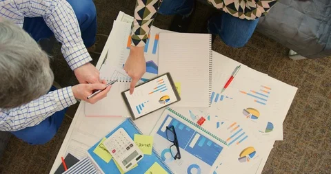 Overhead Of Professionals Discussing Financial Data On Digital Tablet 4K Stock Footage 92369400