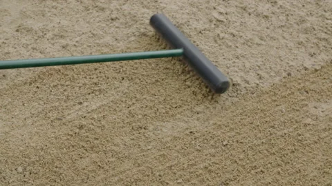 Overhead rake being pushed and pulled through sand trap 스톡 동영상 153697455