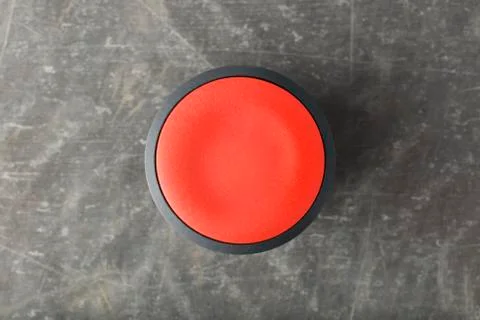 Overhead of Red Circular Push Button on Smooth Concrete Stock Photos