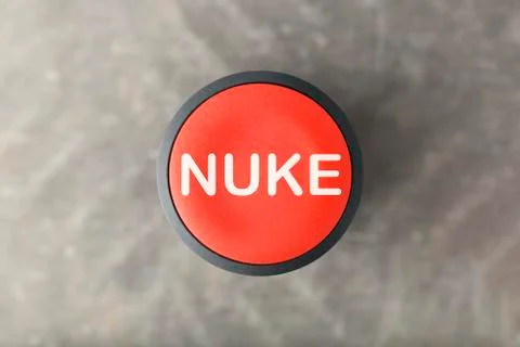 Overhead of Red Nuke Push Button Over Blurred Gray Background Stock Photos