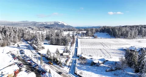 Overhead road shot, tracking a snow plow into trees Pt 1 of 2 - 5K Video stock 227995359
