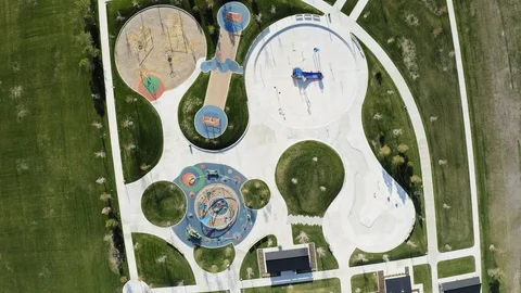 Overhead rotating aerial of splash pad and playground closed for coronavirus Stock Footage 128782981