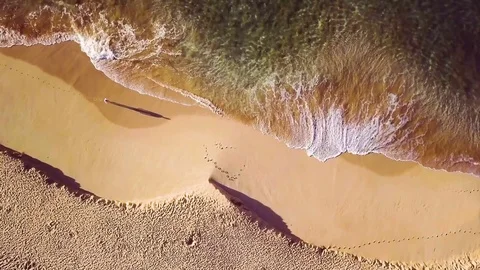  Overhead Rotating Left Shot Of A Solo Man Walking On A Deserted Beach Alone Stock Footage 83959765