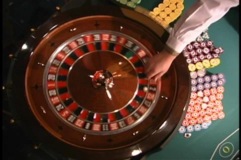 Overhead roulette wheel ball thrown in by dealer Stock Footage 109056