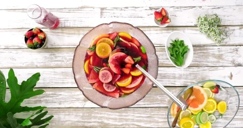 Overhead of sangria making with fresh fruit and mint Stock Footage 81443316