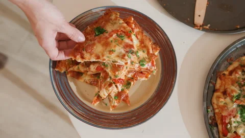 Overhead serving action of hot layered lasagna being lifted from plate beside Stock Footage 343682943