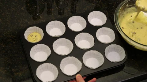 Overhead shot of batter being poured into muffin tray Stock Footage 61404847