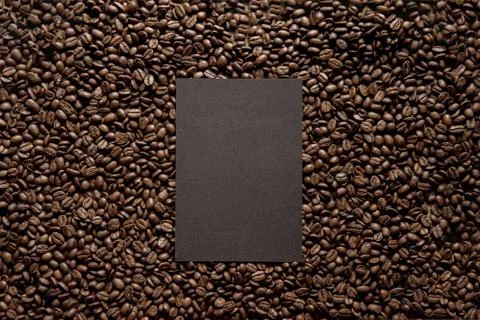 Overhead shot of a black rectangle over coffee beans great for writing a text Stock Photos