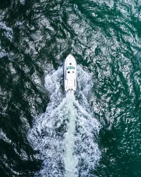 Overhead shot of boat navigating through ocean waves Stock Photos