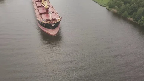 Overhead shot on a bulk carrier ship with cranes in sea port canal Video stock 77839086