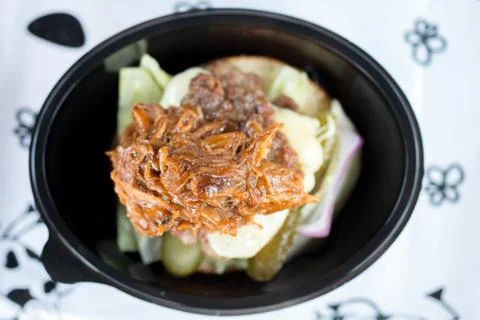 Overhead shot of a burger in a plastic container Stock Photos