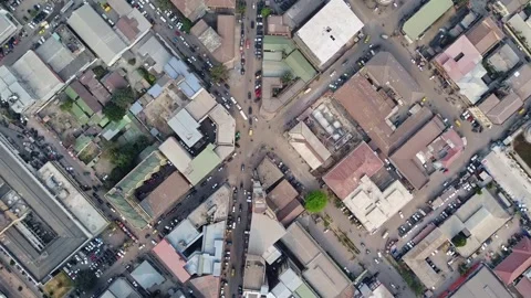 Overhead shot of a busy city intersection with buildings and active traffic flow Stock Footage 317933607