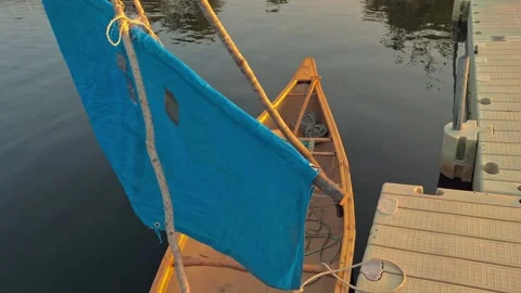 Overhead Shot Of Canoe Moving Gently In The Water With Handmade Blue Sail Stock Footage 255471918