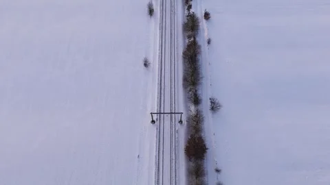 Overhead Shot Captures Snowcovered Fields Intersected By Straight Railway Lines Stock Footage 327051403
