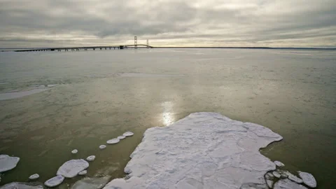 Overhead shot capturing a patchwork of frozen ice formations on the Great Lakes. Video stock 337721023