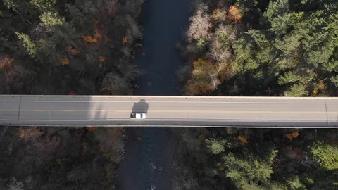Overhead shot of car driving over Elwha river bridge in the forest, 4k Stock Footage