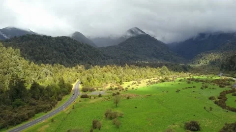 Overhead shot of car driving through winding mountain road, drone 4k Video stock 147227323