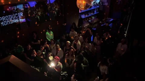 Overhead Shot of Crowd Enjoying Live Music Performance in Dimly Lit Nightclub Stock Footage 336445825