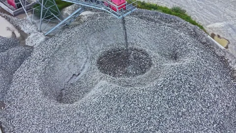 Overhead shot of crushed stone. Drone captures spiral pattern of gravel mound. Stock Footage 337910484