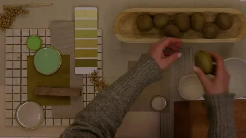 Overhead shot of designer placing handmade ceramic pieces onto natural material  Stock Footage 329827552