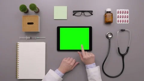 Overhead Shot Of Doctor Using Tablet Computer With Green Screen Stock Footage 79650105
