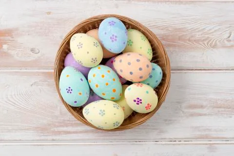 Overhead Shot of Easter Eggs in Wicker Bowl Stock Photos