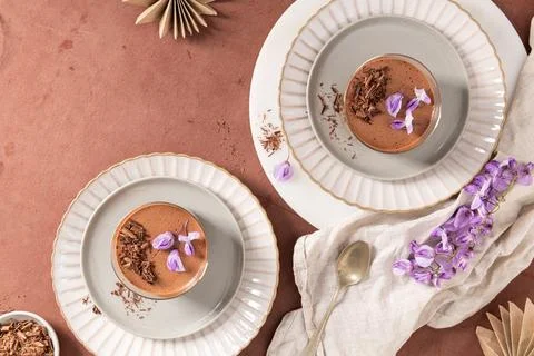 An overhead shot featuring two chocolate mousses in glasses, styled on plat.. Foto stock