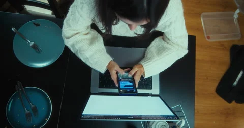 Overhead shot freelancer working at home after dinner using computer at night Stock Footage 220956011