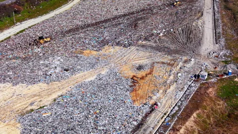 Overhead shot of garbage heap beside dirt access track, Bulgaria Stock Footage 345150625