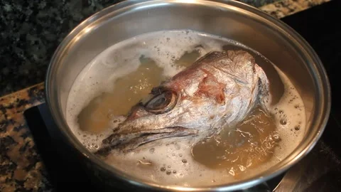 Overhead shot of hake head boiling in pot for fish broth 動画素材 345749354