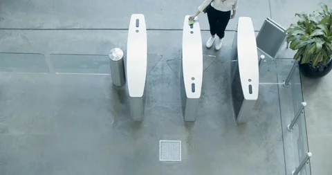 Overhead shot of handshake by security gates in an office Stock Footage 116344008