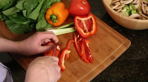 Overhead shot of man cutting red bell pepper Stock Footage 61405563