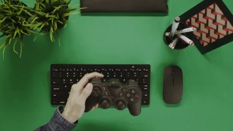 Overhead shot of man gaming on computer by using gamepad Stock Footage 81232048