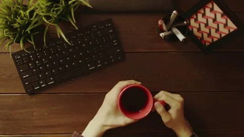Overhead shot of man gesticulating in front of computer with cup of tea in his Stock Footage 81174619