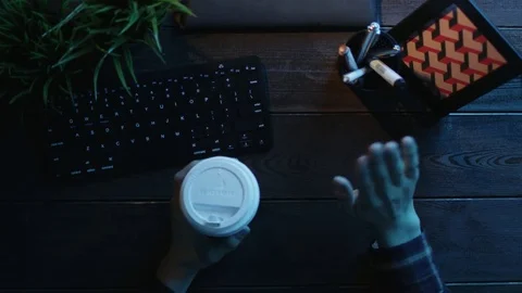 Overhead shot of man having video chat and gesticulating while drinking coffee Stock Footage 81165856